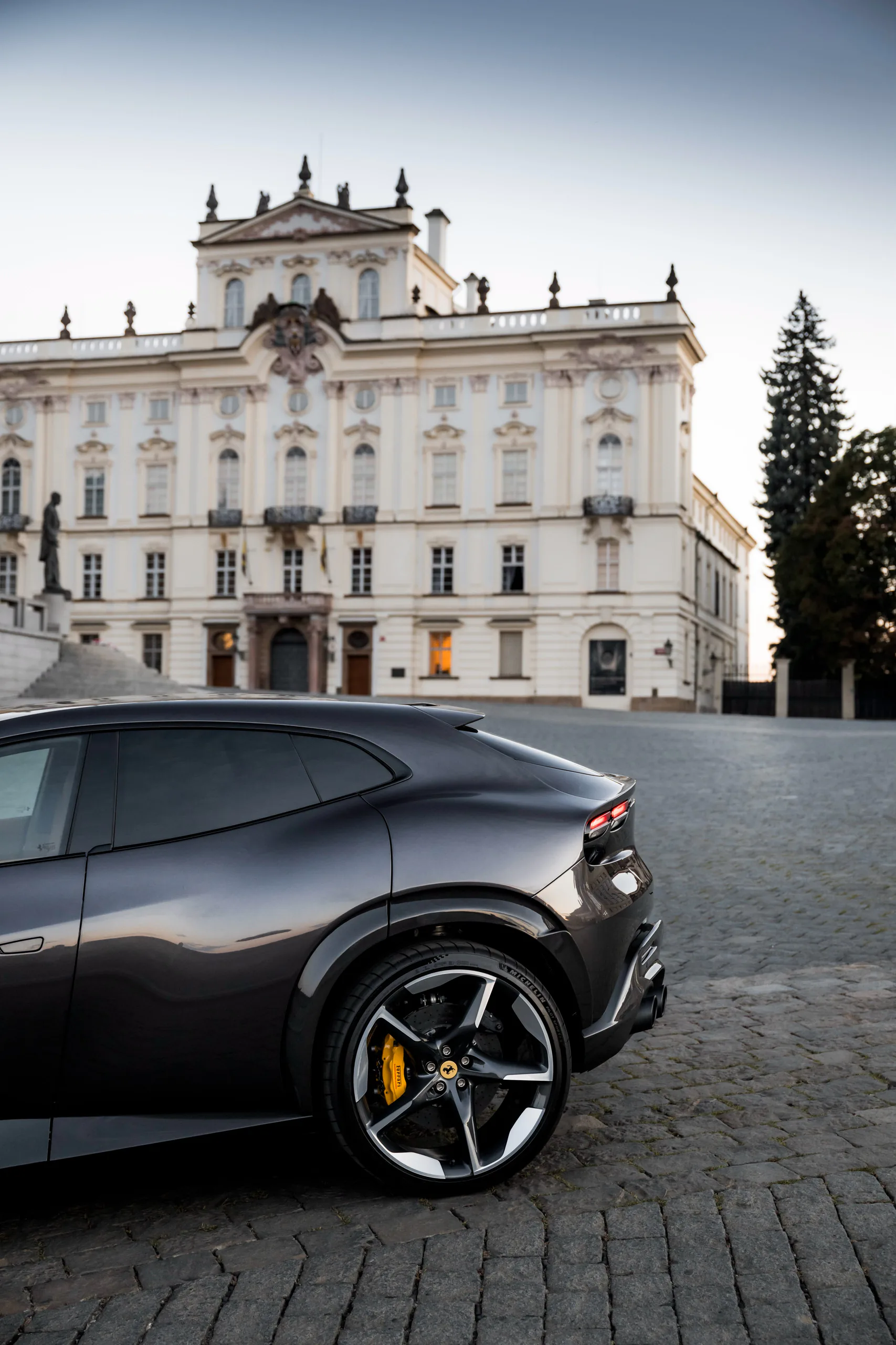 Ferrari Purosangue rear quarter in front of the Archbishop's Palace