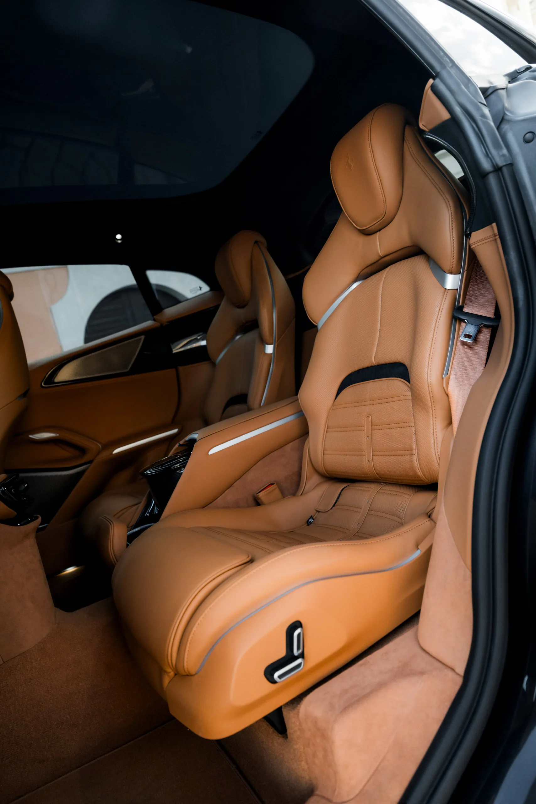 Purosangue rear-hinged door open to tan leather seats