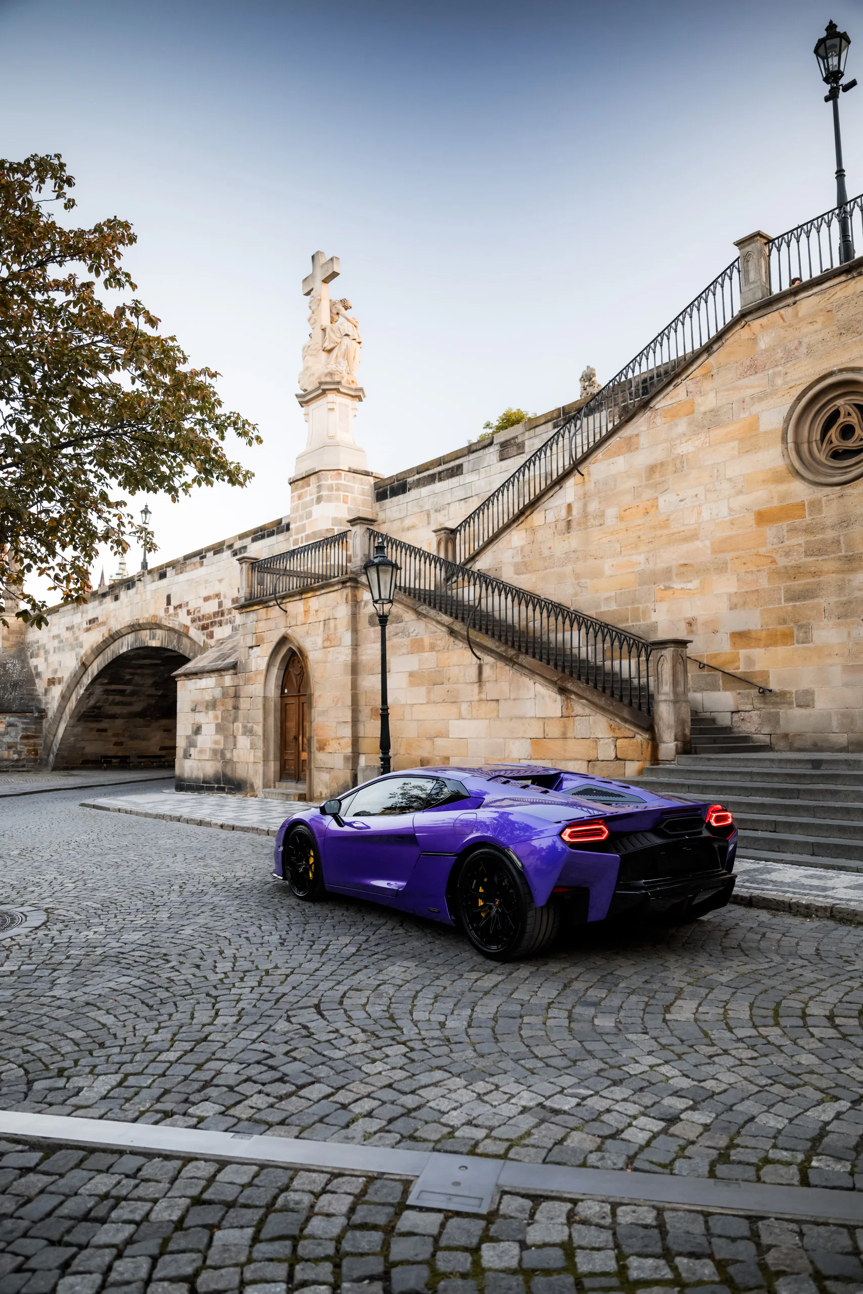 Lamborghini Temerario rear three-quarter beside the Charles Bridge tower
